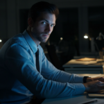 Employee using unauthorized AI tools alone in dark office after hours — shadow AI risk